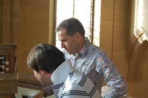Ben Parry discusses the score with the organist Matthew Martin